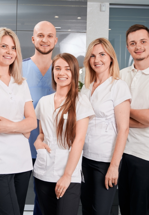 The Lindsey Family Dental team smiling in a grassy field