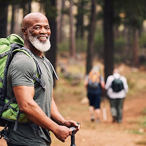 Senior man smiling on hiking trail