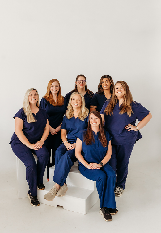 The Madison dental team at Lindsey Family Dental smiling in a grassy field