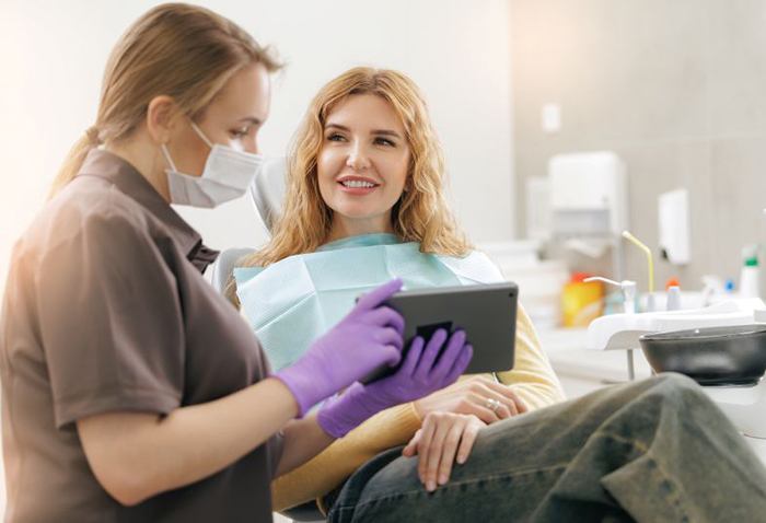 Patient and dental team member talking during consultation