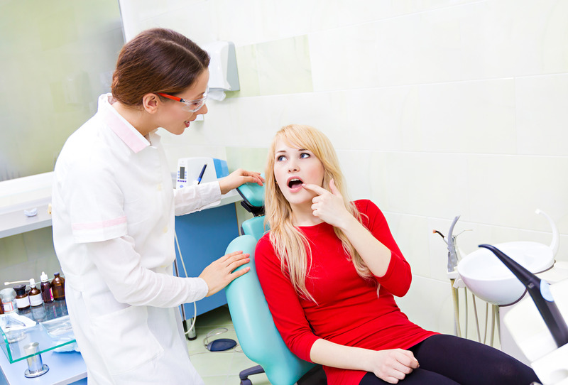 Patient talking to dentist about dental emergencies