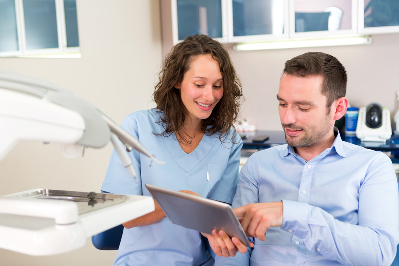 Patient talking to dentist about oral health